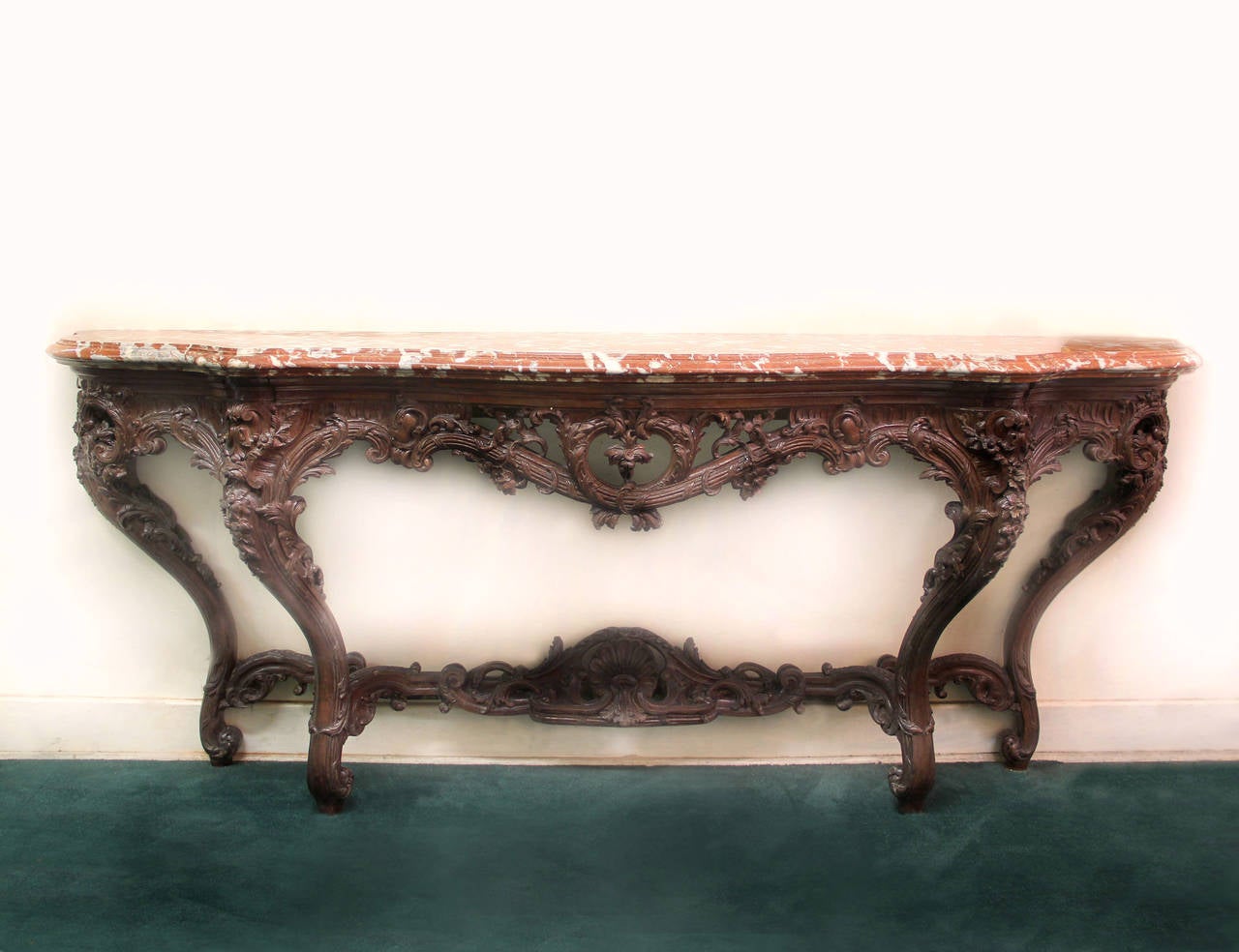 A large and important late 19th century Louis XV style carved oak console.

A thick molded Rouge de Maine marble top above hand-carved flower petals and acanthus leaves. The bottom stretcher is centered with a sea shell.

Stamped Gaumeloose to the