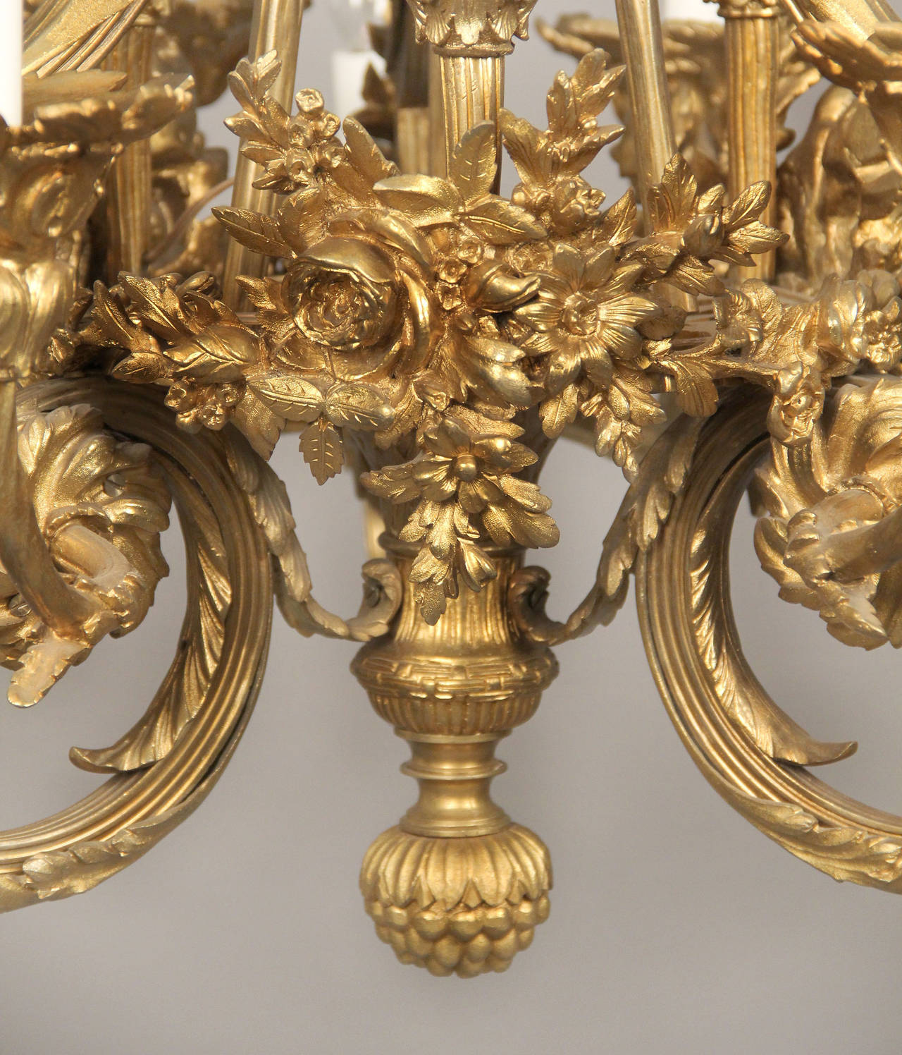 A fine late 19th century gilt bronze twelve-light chandelier.

Great quality bronze casted frame, bottom center with a basket and flowers, foliate scrolled arms, the top with flowers and bows. Twelve tiered perimeter lights.

If you are looking