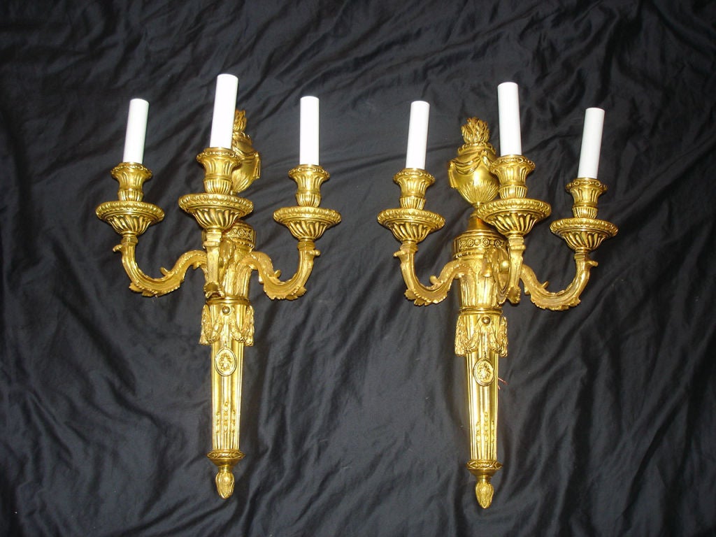 A pair of beautiful quality late 19th century gilt bronze three light sconces.

If you are looking for a chandelier, a lantern or sets of sconces, Charles Cheriff Galleries is the right place to come. We have over 300 chandeliers in our inventory,