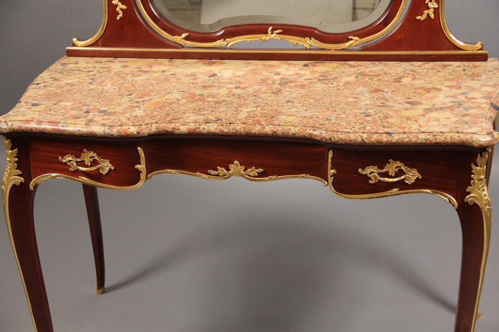 A Beautiful Late 19th Century Gilt Bronze Mounted Louis XV Style Dressing Table

By François Linke

Index number 283

Swing beveled mirror within a conforming support, above a serpentine-fronted Brèche d'Alep marble top, the wavy frieze set