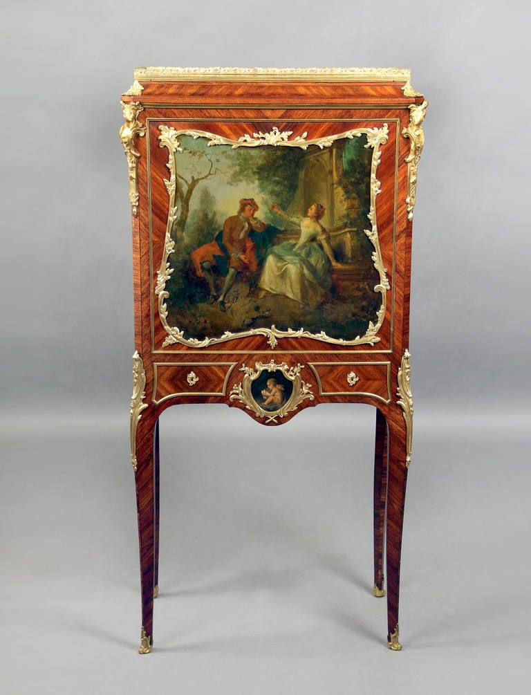 A lovely late 19th century Louis XV style gilt bronze mounted Vernis Martin ladies secretaire cabinet.

By Paul Sormani.

The rectangular upper section topped by a bronze gallery, above a fall front set with a painted panel of loving couple,