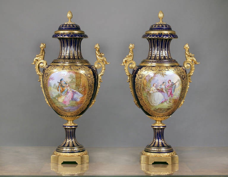 A Wonderful Pair of Late 19th Century Bronze Mounted Sèvres Style Cobalt Blue Porcelain Vases and Covers 

Signed Bertren  

 Each of baluster form with domed cover with pine cone finial, above a waisted neck and bulbous body finely painted with