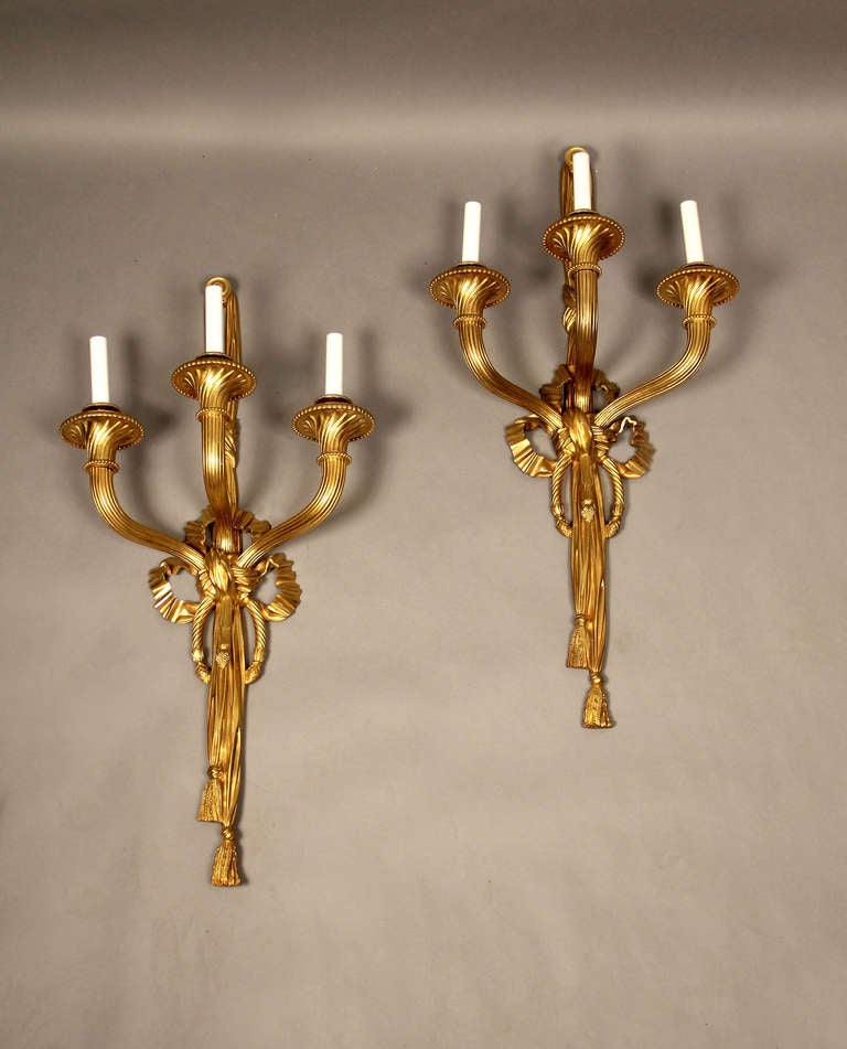 A pair of large and great quality late 19th century gilt bronze three-arm sconces.

 