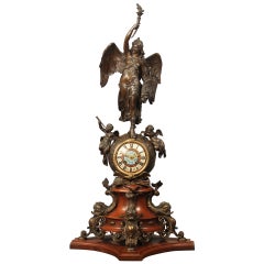 Importante horloge de cheminée en bronze patiné et doré de la fin du XIXe siècle