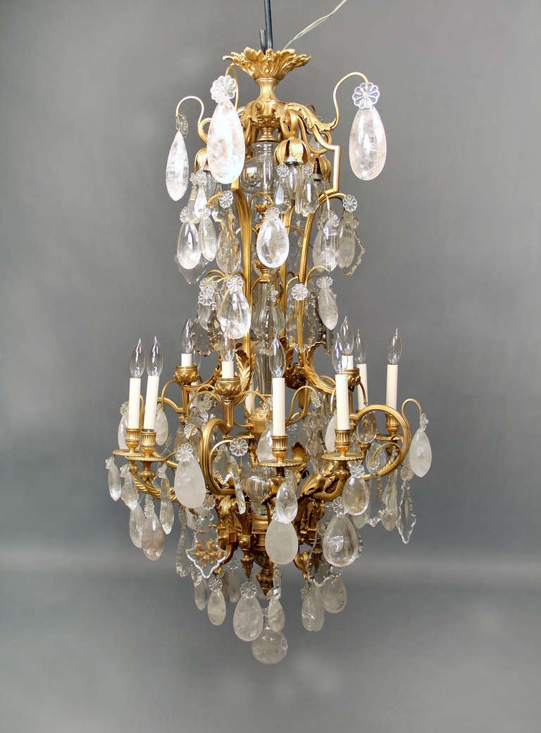 A stunning late 19th century gilt bronze, crystal and rock crystal sixteen-light chandelier.

Fantastic casted rope bronze arms with full pear shaped rock crystal, cut crystal central column, eight perimeter and eight-tiered interior lights.

If you