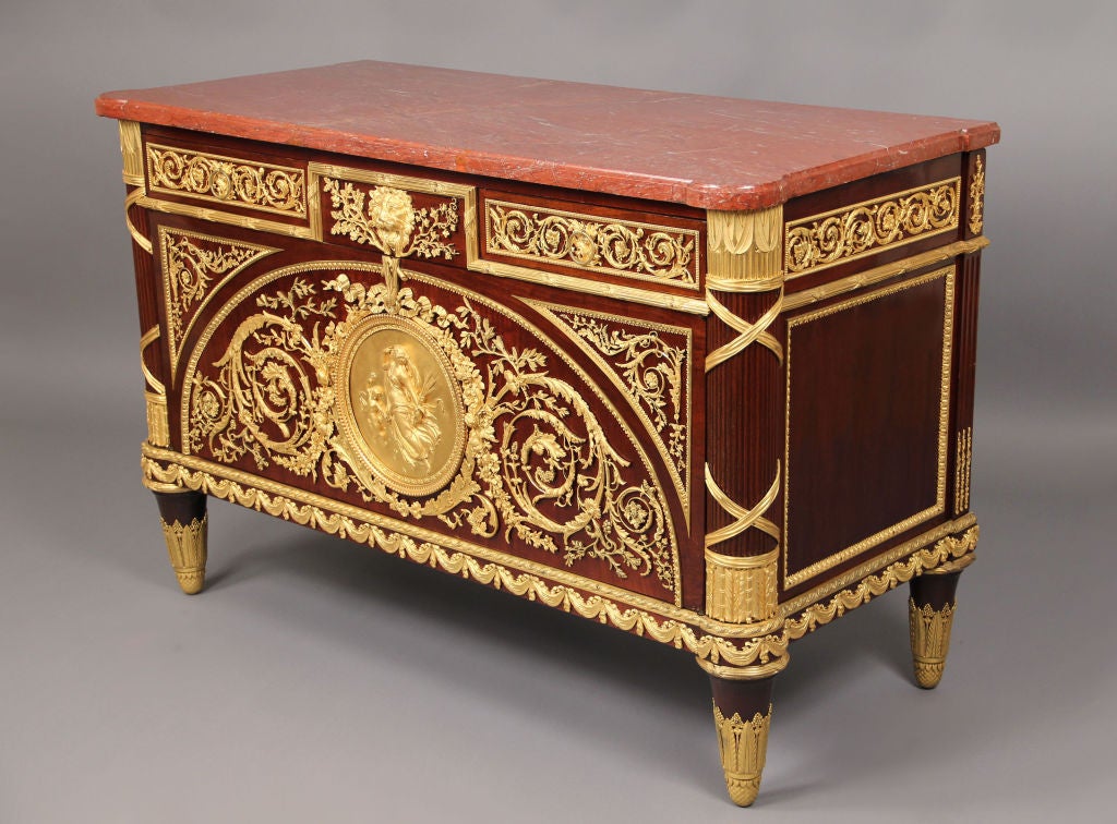 A Fantastic Quality Mid 19th Century Gilt Bronze Mounted Louis XVI Style Mahogany Commode

By Pretot

A marble top above a frieze applied with scrolling-vine mounts and fronted by two drawers centered by a lion's mask and oak branches, the cupboard