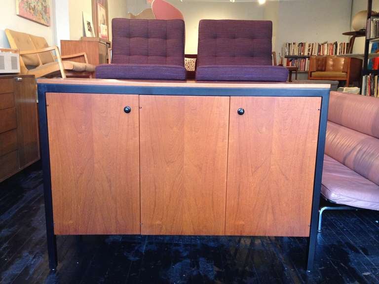 Rare Two Door Teak Buffet Cabinet designed by George Nelson for Herman Miller in 1961.
Three doors enclosing two shallow and one deep pullout tray drawers.
Two adjustable shelves.