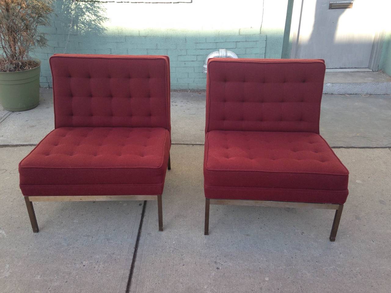 Pair of upholstered Lounge chairs designed by Florence Knoll for Knoll International in 1958, tubular steel frame, burgundy wool hopsack fabric.