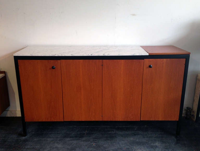 Marble top Black Frame Group Double Buffet designed by George Nelson for Herman Miller in 1959. Four doors enclosing four shallow pull-out trays and two adjustable shelves. Lift lid enclosing hot plate. These cabinets are some of the rarest and most