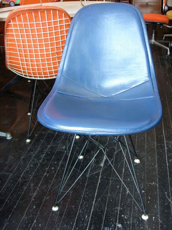 A set of 4 vintage Eames Eiffel tower chairs , vinyl covers over white wire tops on black eiffel bases. Priced for the set .