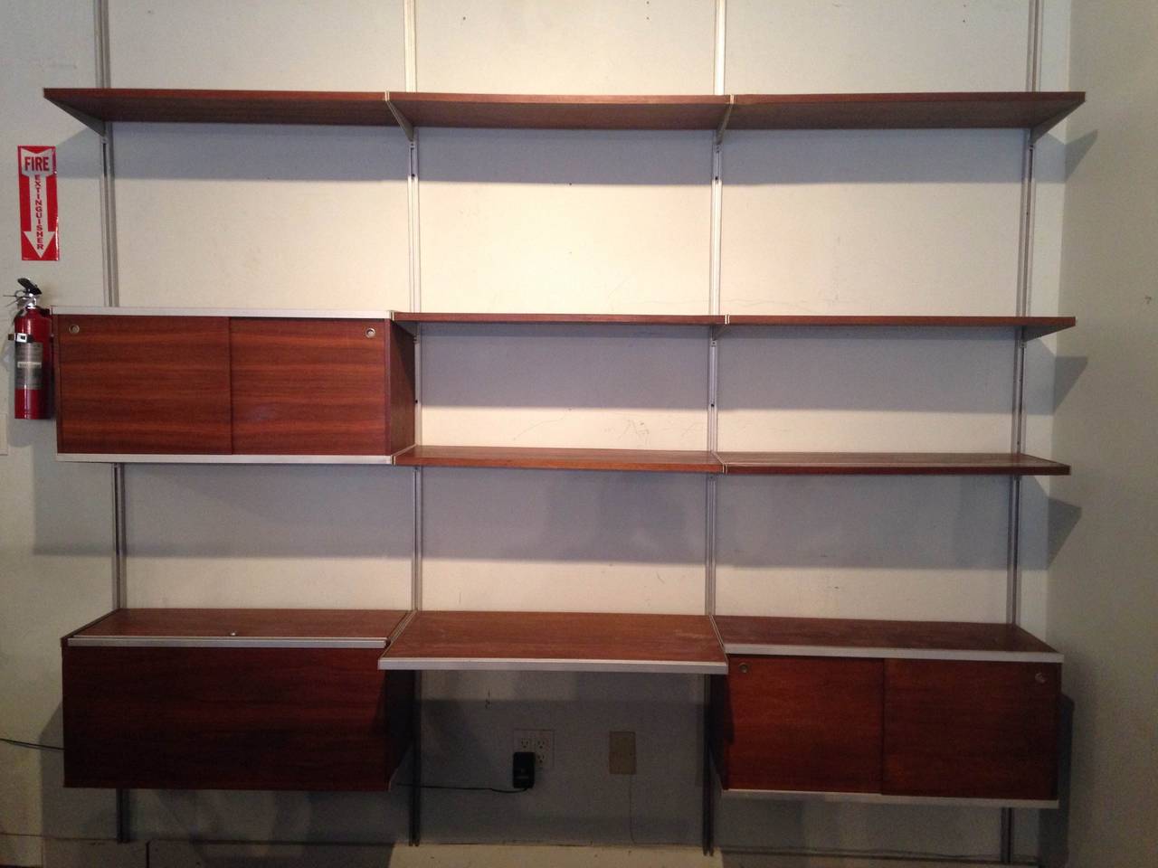 Wall-mount 3 Bay CSS, designed by George Nelson for Herman Miller,
walnut shelves an cabinets.

: BRIGHT LYONS specializes in George Nelson's CSS storage system of 1959. We currently have over 30 bays available with many different cabinet,