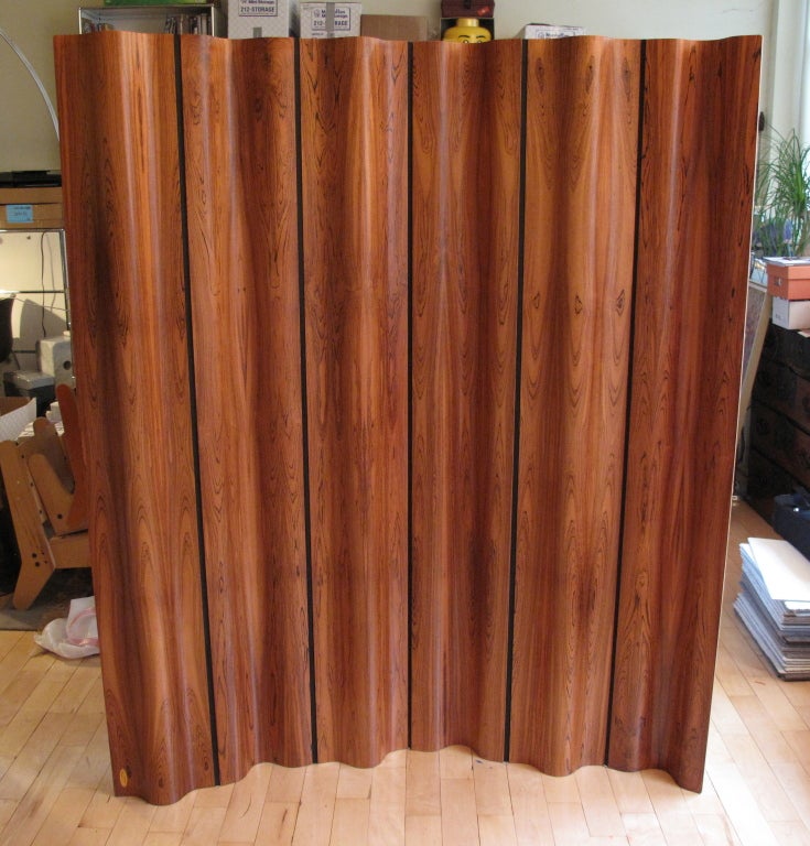 Molded plywood screen designed by Charles and Ray Eames for Herman Miller in 1946. This screen, in rosewood, was part of a special edition of 500 produced by Herman Miller in 1996. Numbered 131.