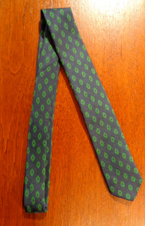 Rare necktie, designed by Alexander Girard for Herman Miller. Navy blue with green shapes.