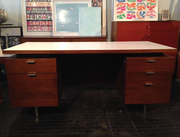 Double pedestal desk designed by George Nelson, manufactured by Herman Miller, 1964 (Executive Office Group). Walnut, floating white laminate top.