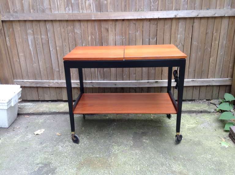 Black Frame Serving Cart designed by George Nelson and produced by Herman Miller 1960-1962. Oil teak cart top with blackened wood frame. Furnished with sliding top and hot plate.