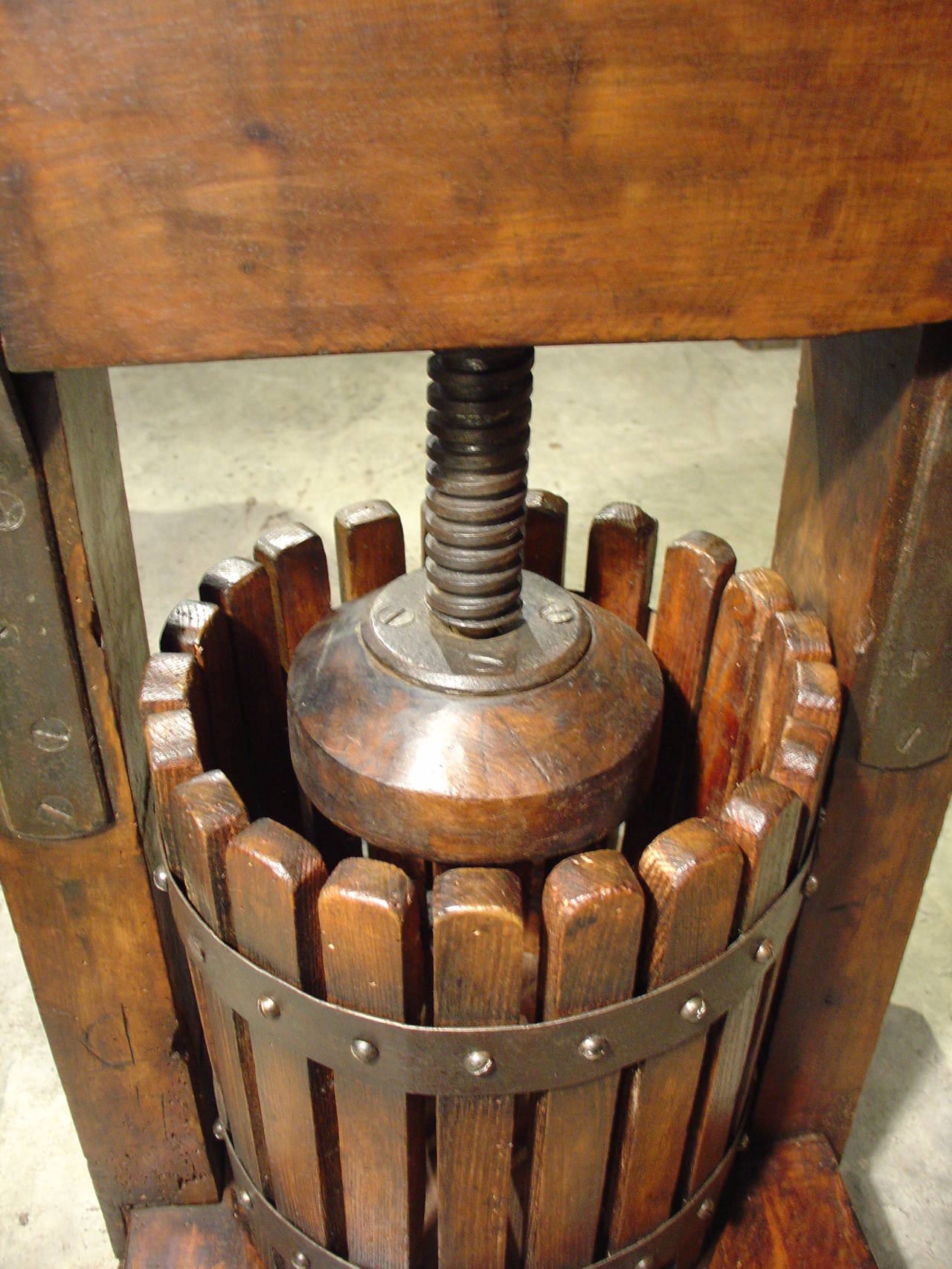 This charming French wine press dates to the 1800s. The grapes go into the barrel, then they are crushed with the iron piece at the top, and finally it pours out from the basket into the spout which should have a container below it to receive the