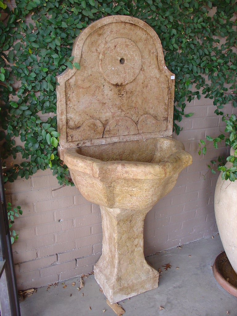 

This elegant antique Italian wall fountain was part of a group of wall fountains from an estate in Italy.
This antique Italian, hand carved wall fountain or powder room sink was made from marble quarried in Verrone, Piedmont, Italy.  We believe