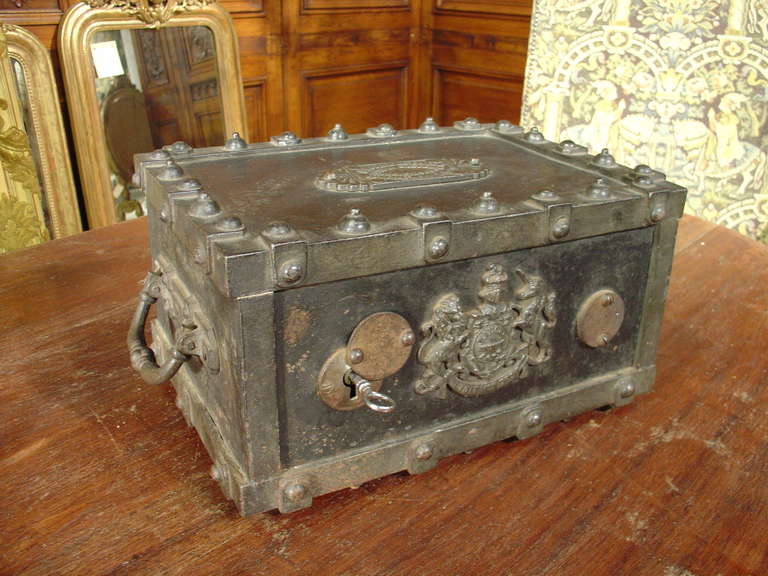 This antique French iron safe is just the right size for smaller valuables. The safe is all iron except for the felt lined cardboard liners which would protect jewelry or valuables.  The motifs are a coat of arms with a lion and unicorn supporter. 
