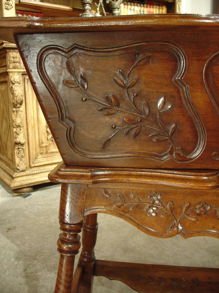 This is a French petrin/maie made of walnut wood. It is carved with beautiful musical motifs and we believe it to be circa 1950. The petrin was originally used to knead dough. The cover lifts up for ease of use and closes while the bread raises.