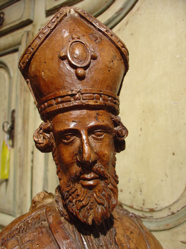 This is a magnificent antique hand carved French reliquary bust of a Bishop dating back to the 1600’s.  It is made from French walnut wood with traces of old polychrome.  There is a round wax seal on the front. 
Reliquaries came in varying sizes