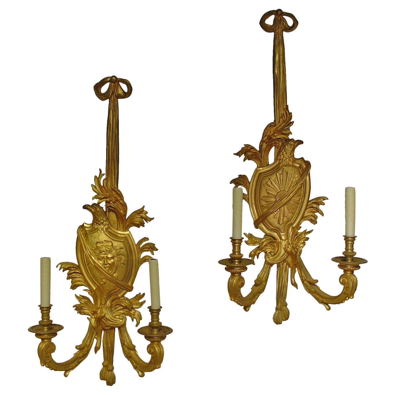 This radiant pair of antique French bronze doré sconces measure about 41” in height! Their style can be considered transitional, since we can see motifs from both Louis XV and Louis XVI (although mostly Louis XVI). The ornamentation on the central