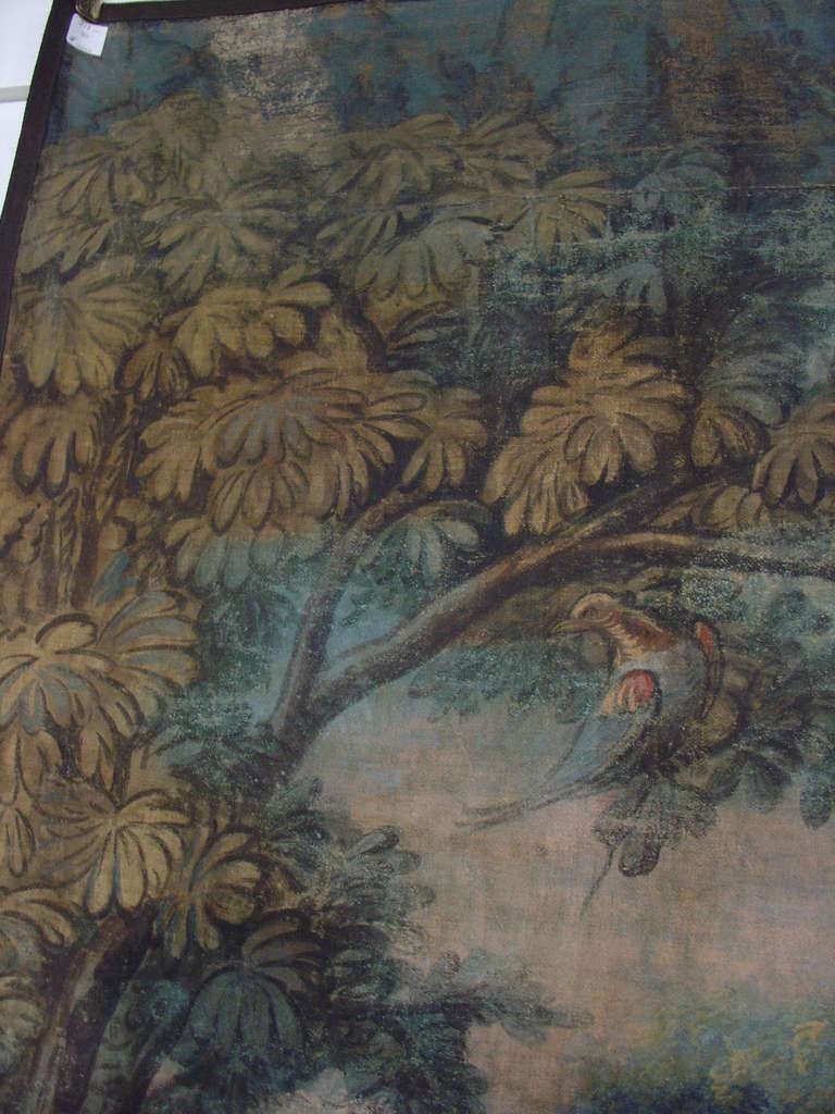 This antique French painting by an unknown artist has beautifully achieved what we believe to be a depiction of an Aubusson tapestry panel.  The overall colors, the very stylized version of the birds and foliage possibly points to a representation