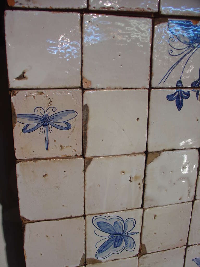 The tiles are mounted on a wooden backing and the 3 panels are connected with metal brackets. All 3 sections are reinforced with 2x4's for stability. Age: Circa 1890

The word azulejo literally means 