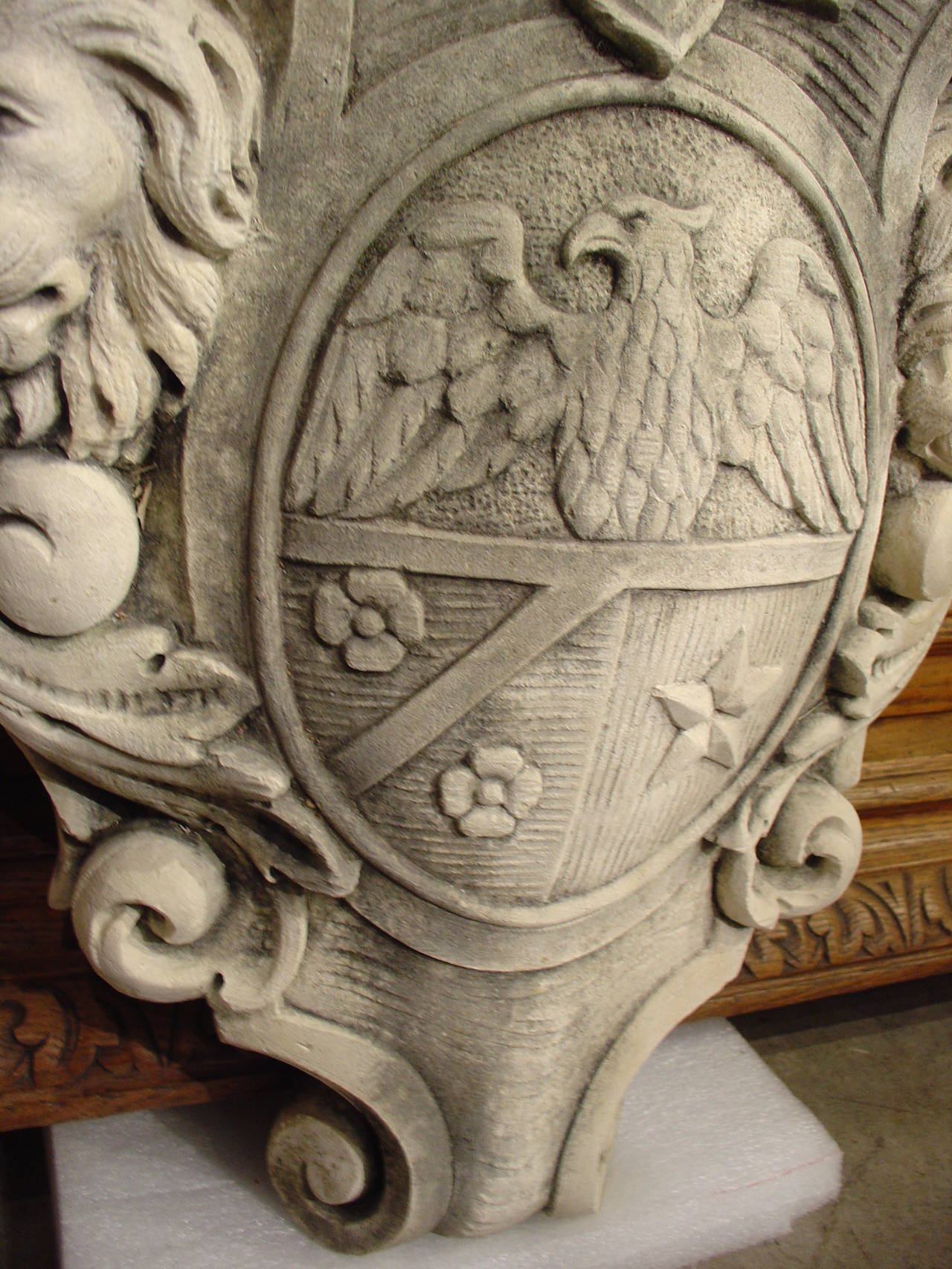 This Italian coat of arms made from limestone, has a wonderful aged patina from being outside.  There is a stylized crown at the top or crest area with a knight’s helmet beneath.  The shield is within an escutcheon shape featuring an eagle, a star