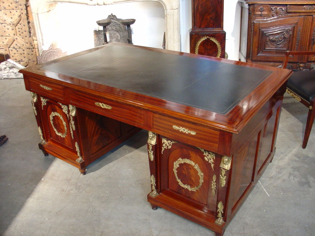 This is a French Empire Style Partner’s Desk with Chair – Mahogany with Ormolu Mounts and Embossed Leather Top – Chair has Leather Upholstery – Excellent Condition – Circa 1950

This formal French partner’s desk has beautifully matched flame
