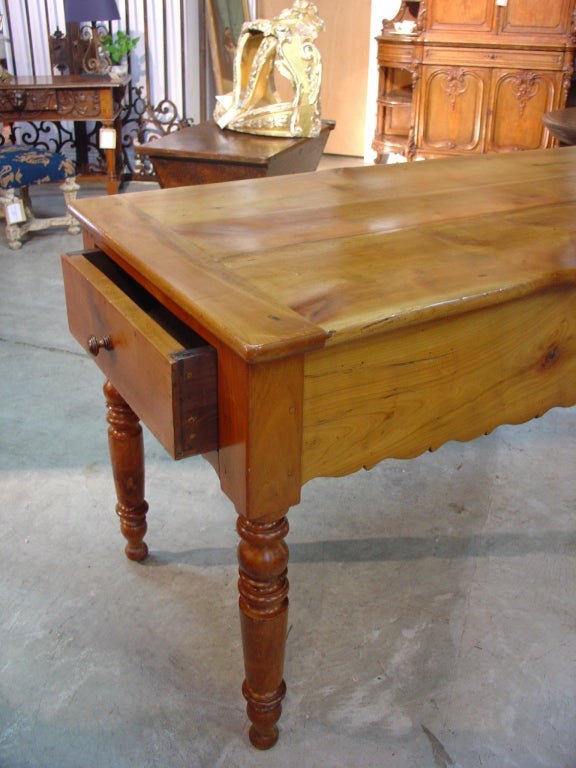 This versatile antique French, narrow table has a very light, fresh color to its fruitwood. Its narrow depth allows it to be used for many purposes: as a sofa table, a kitchen island (marble could also be placed on its top), entrance table, library