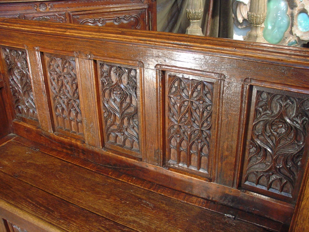his majestic antique French Gothic style bench/trunk came from a chateau owned by a gentleman in Normandy.  French Gothic hand carved motifs are on the five seat back panels and five trunk frontage panels.  The ends or side panels repeat the linen