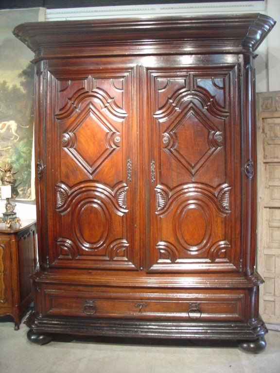 FRANCE-Circa 1700<br />
Possibly from the Bearn region of Southwestern France, this majestic armoire from the period of Louis XIV, features a structure with bold contours and deep relief moldings, yet, overall graceful lines.  Generally, the lines