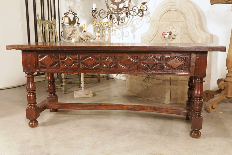 This bold and impressive French table is from the Southwestern Region of France, and shows characteristics of Spanish influence. These tables were usually centered in a furniture grouping so you could see all sides.  Because they were rectangular