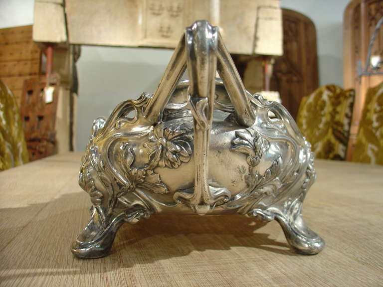 Victor Saglier was known for his artistry in silver.  Working in silver, silverplate and gold, he was best known for his work during the very beginning of the art nouveau period.  His pieces were elegant and flowing, featuring natural forms of all