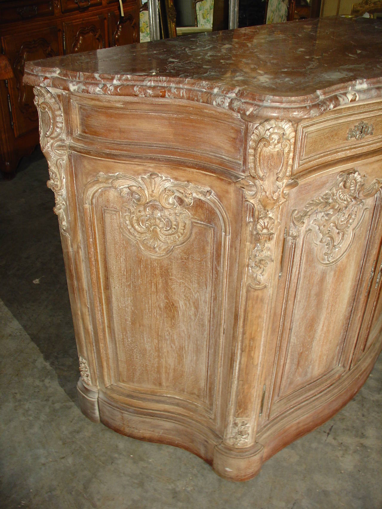 This stunning antique French Buffet de Chasse has  two drawers and a beautifully shaped front and sides, with a shaped original piece of rouge marble on top. There are s-curves on the sides with the backs of the sides extending out further than the