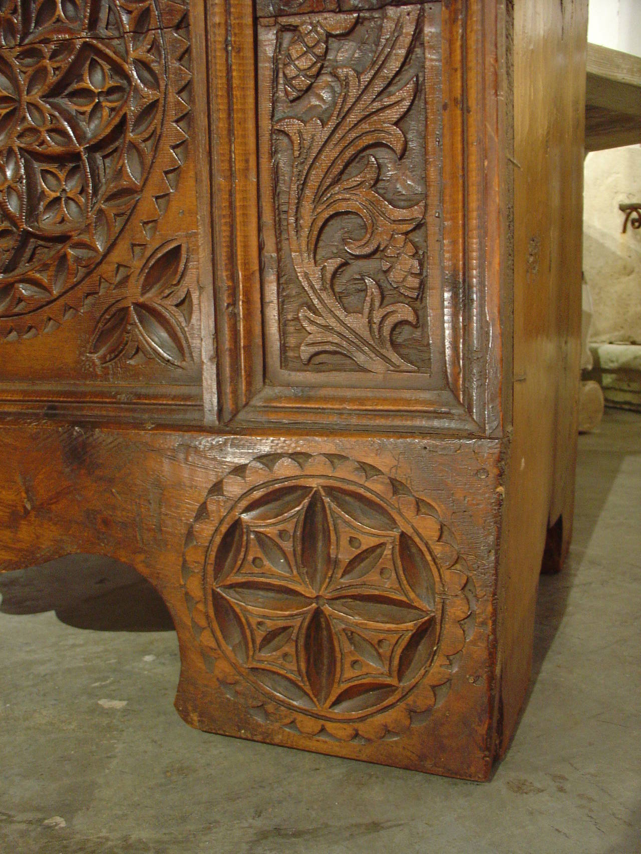 This impressive 18th C. wooden trunk from Switzerland has interesting and deeply, hand carved motifs on its top and front. This may have been a wedding trunk because of the different shapes of the shields depicted on the top indented panels.  One