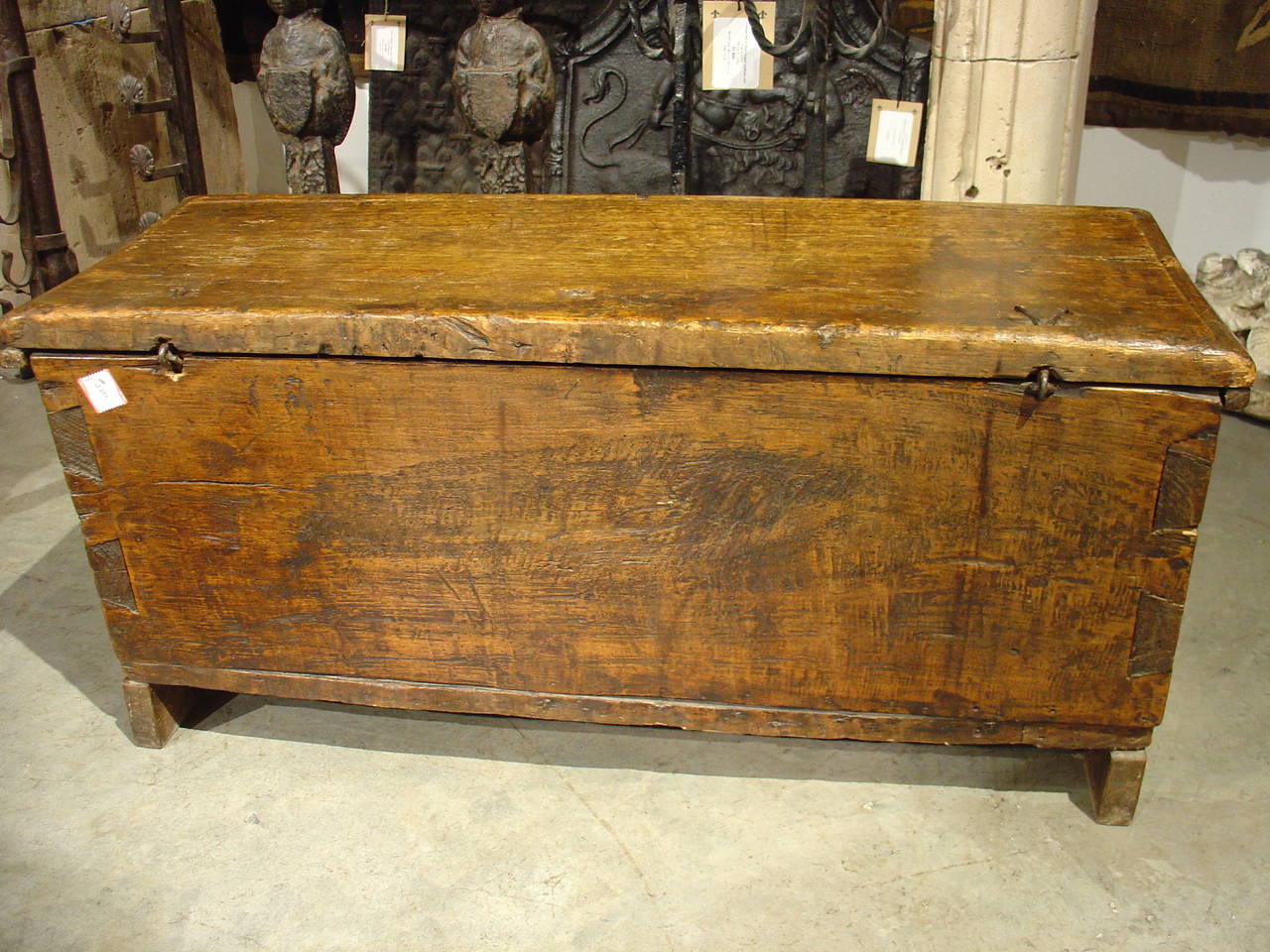 Charming small French trunk from the 1700's with nice thick top and original hinges. Single plank top and back boards.

This trunk has been made with dovetail construction using thick pieces of European Oak.  It has two hand carved shields on the