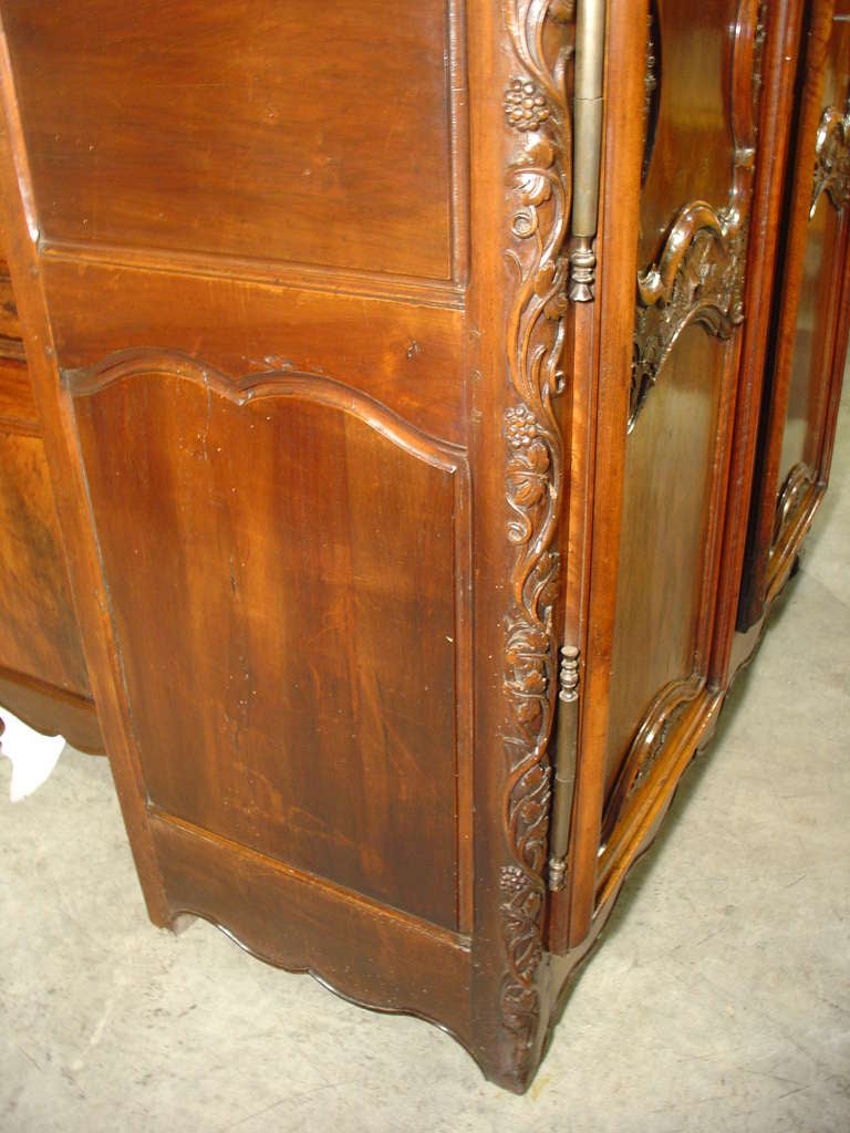 This stunning 18th C. Lyonnaise Armoire is from the Vallee du Rhone and has beautiful hand carved grapevine and foliate motifs throughout the piece.   Most likely the family who commissioned this armoire was in the wine industry.  Cabinetmakers from