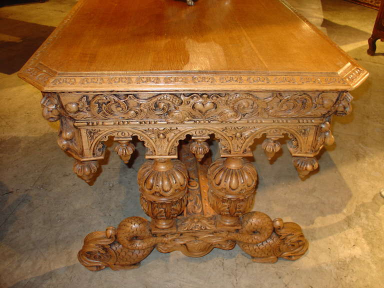 This is an amazing stripped European Oak desk we found in France on our last trip. It is heavily carved and adorned on all sides with French dolphins... Even its feet are large, stylized dolphins.. It's quite an extraordinary table. 

This