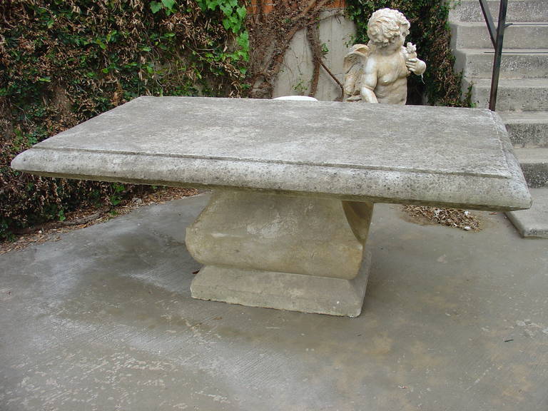 This awesome hand-carved rectangular limestone table from France will make a statement wherever it is placed inside or out. It has a shaped pedestal on a square plinth, beneath a rectangular top with a shaped surround. This table can be used in a