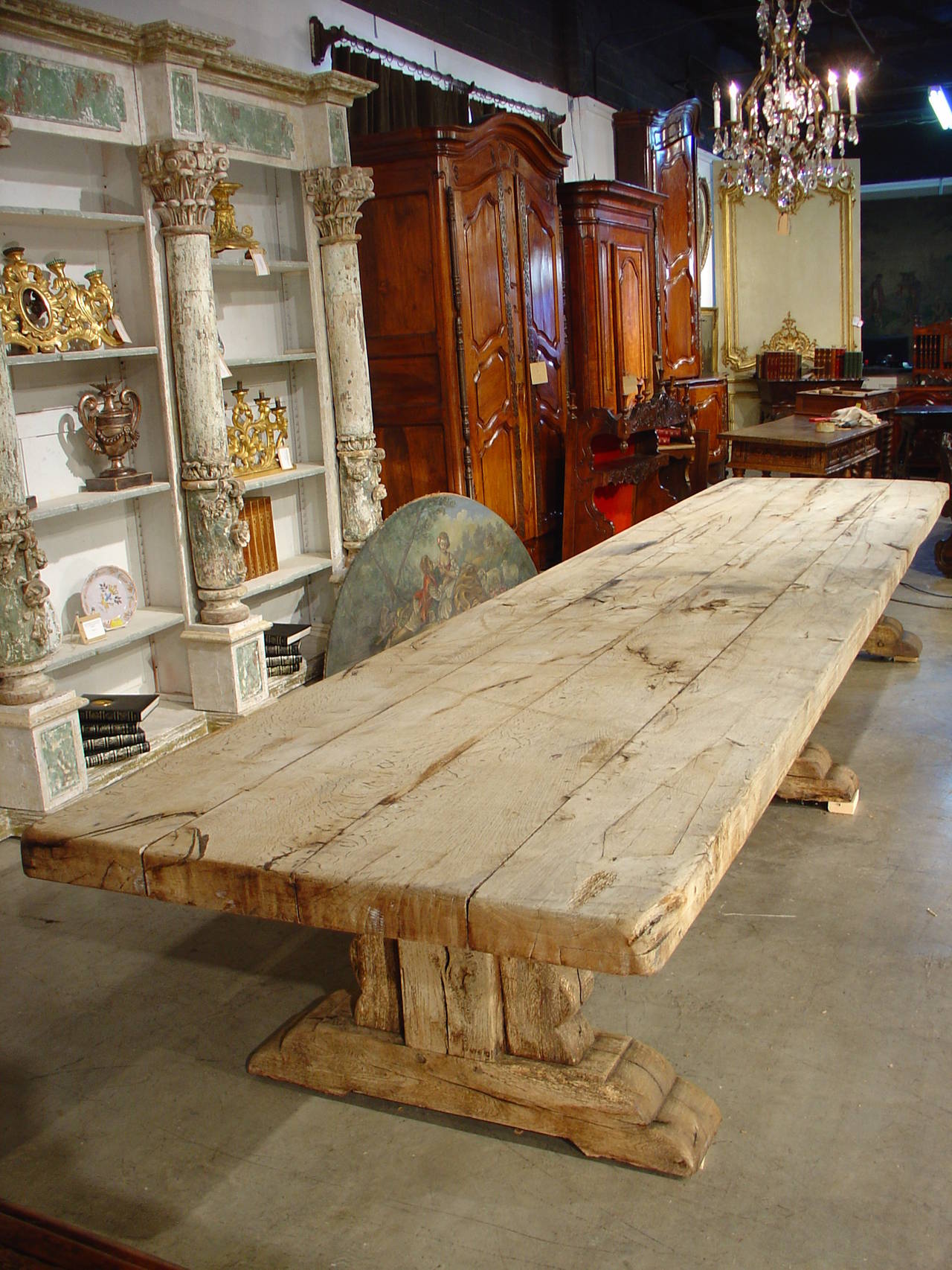 This monumental antique table is made of stripped French oak, and is the largest table we have ever found. It has beautiful thick proportions, and the top boards run the entire length of the table at over 16 feet long. It could easily seat 20