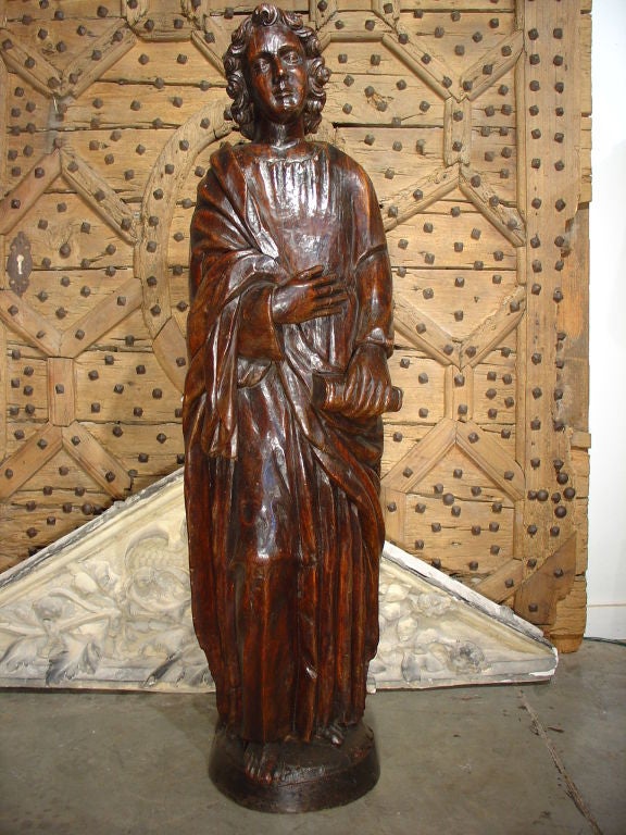 This magnificent tall 18th C. French religious statue was hand carved from walnut wood.  Religious statues of this size and age are highly sought after and would be an attribute to any home.