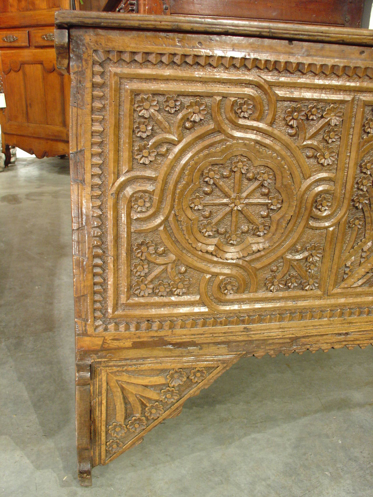 This amazing antique trunk from the 1600’s originated in Seville, Spain.  The entire trunk has been hand carved and joined together.  The front has three panels with a myriad of motifs.  The center panel is in perspective with columns, arches and