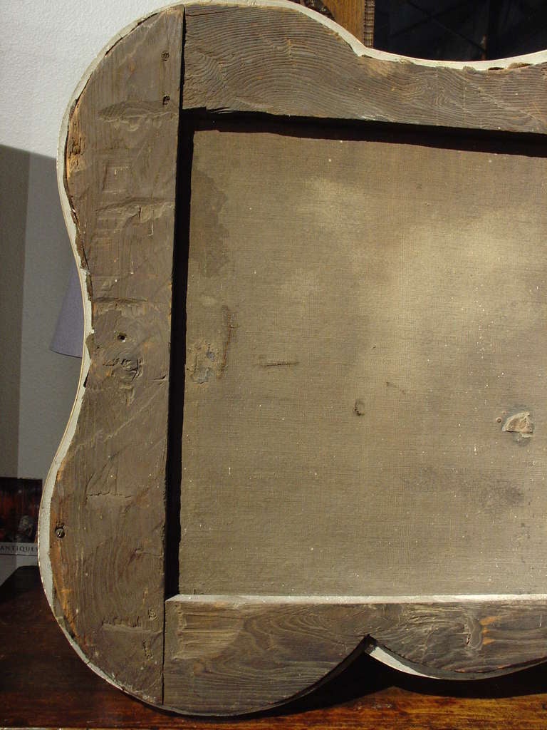 This charming antique French overdoor painting was once part of a boiserie or wooden paneled room in the 1700’s. Often, paintings of scenes of everyday life (genre scenes), were placed into frames which duplicated the moldings used in the room. They