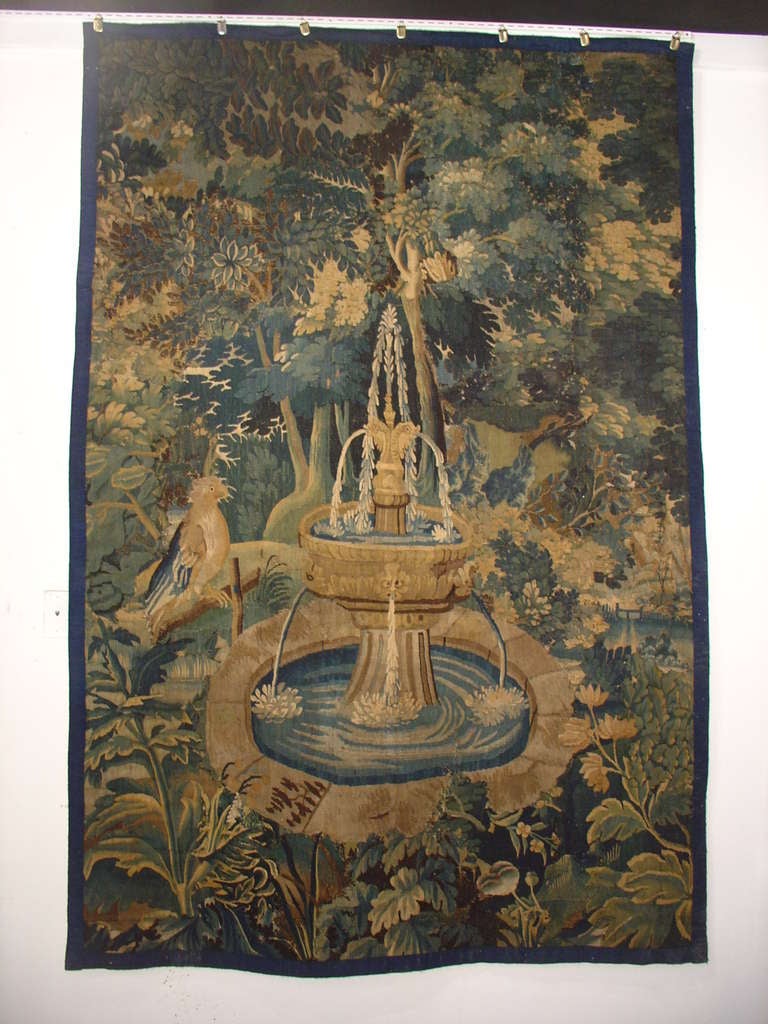 This antique French tapestry is from the 1700’s and is most likely a fragment from a much larger tapestry.  The Revolution left many tapestries in fragments as did the architectural changes from massive walls to smaller rooms.  That we even have