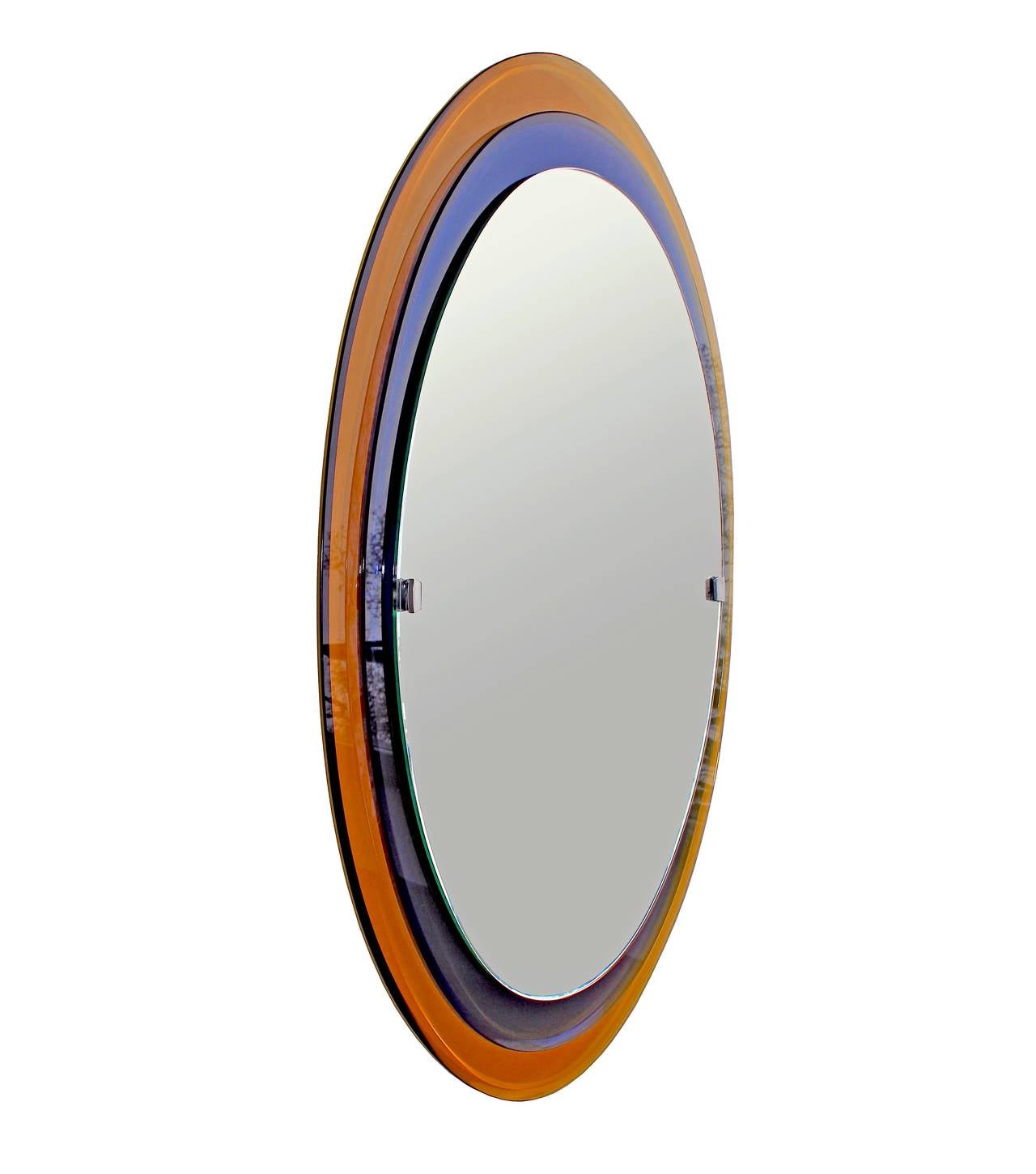 Oval stepped mirror in yellow and blue glass with nickelled brass mounts by Fontana Arte. 
Model no: 2046. Retains original label on mirror pane and also 'Fontanit' label on back.
Documented in Quaderni di Fontana Arte 1964.