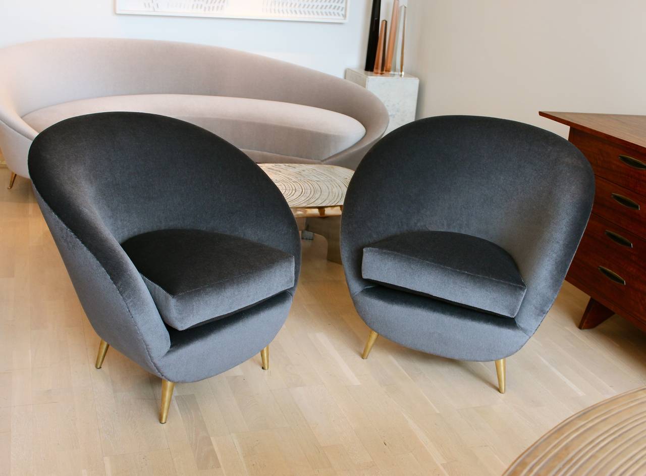 Pair of curved Italian armchairs in mohair with conical brass feet.