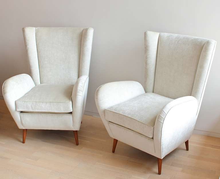 Pair of Italian armchairs with wooden feet in the style of Paolo Buffa.