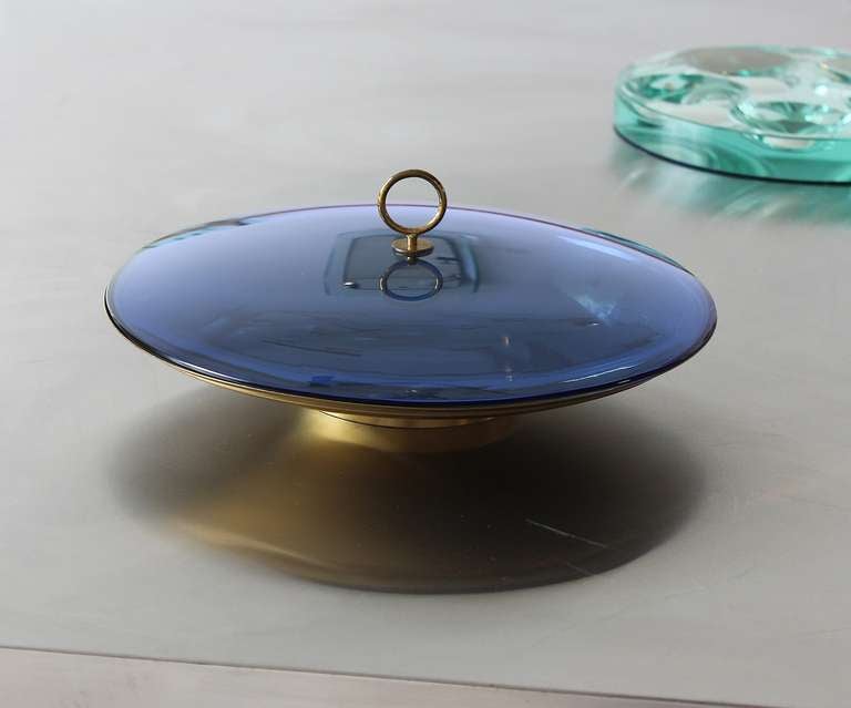 Brass dish with blue bevelled glass lid and brass finial.