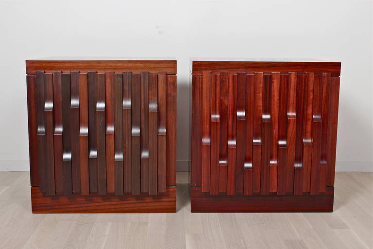 Pair of 'Norman' side cabinets in African walnut by Luciano Frigerio.
Single door enclosing one shelf.